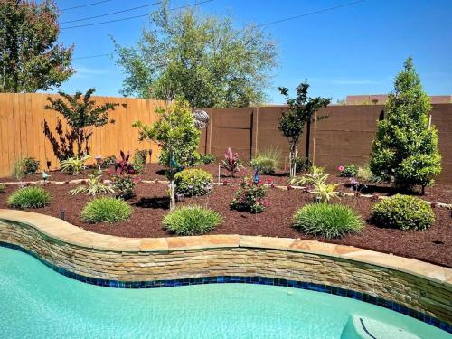 Landscaping in West Ranch, Subdivision, Friendswood. Behind pool landscape.