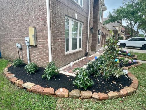 Landscape design, moss rock border, new mulch, new plant bed