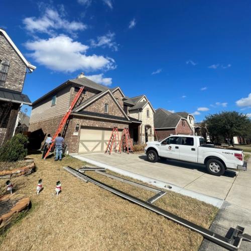 Yard Works men installing new gutters on house in League City