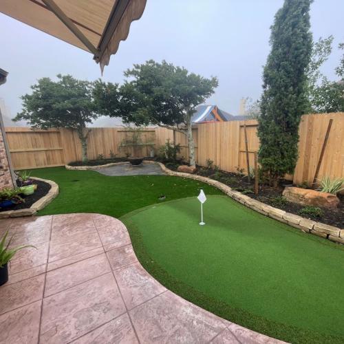 newly installed turf putting green in backyard